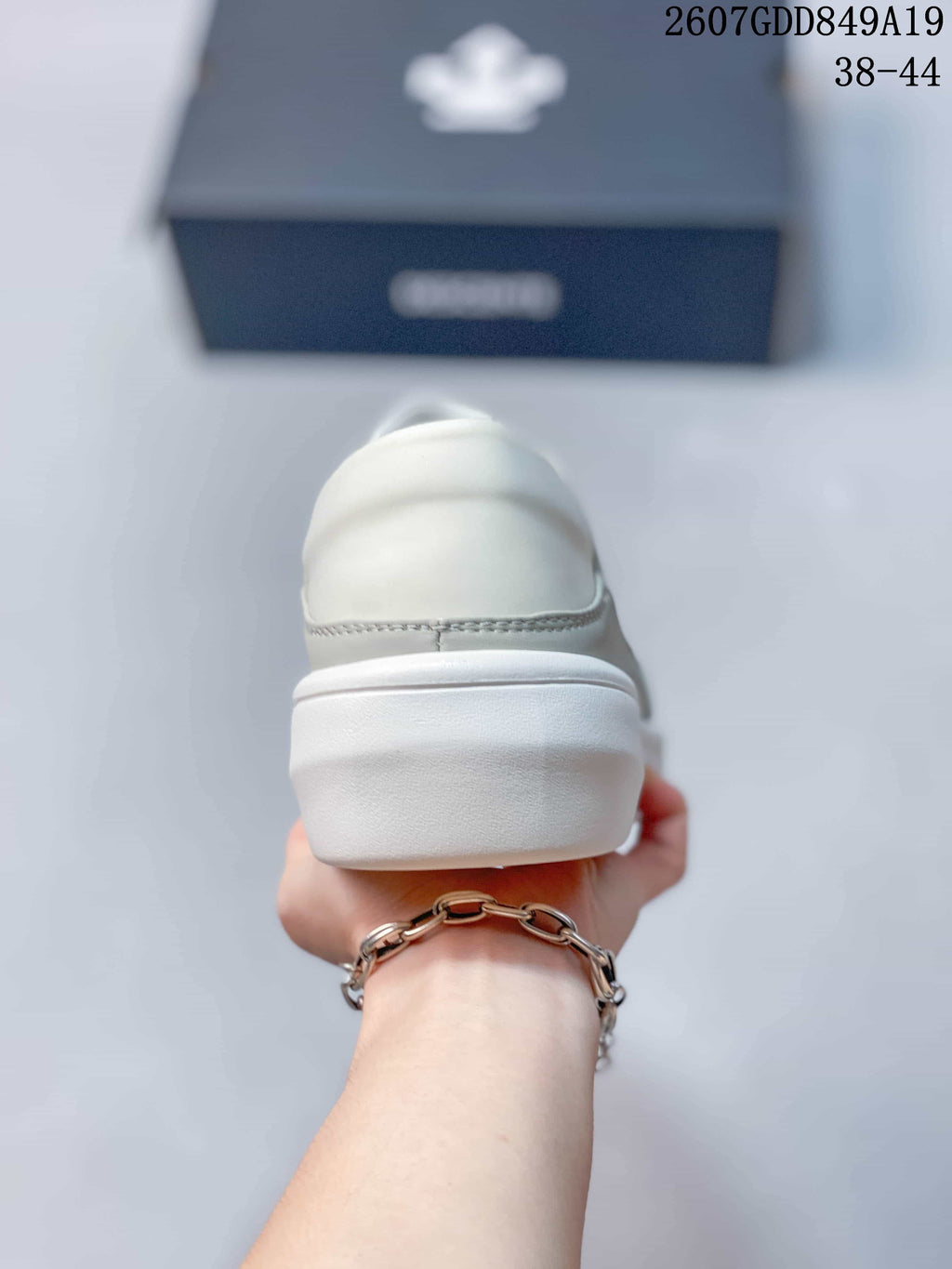 Rear view of the sneaker showing the padded heel area and raised white outsole.