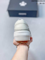 Rear view of the sneaker showing the padded heel area and raised white outsole.