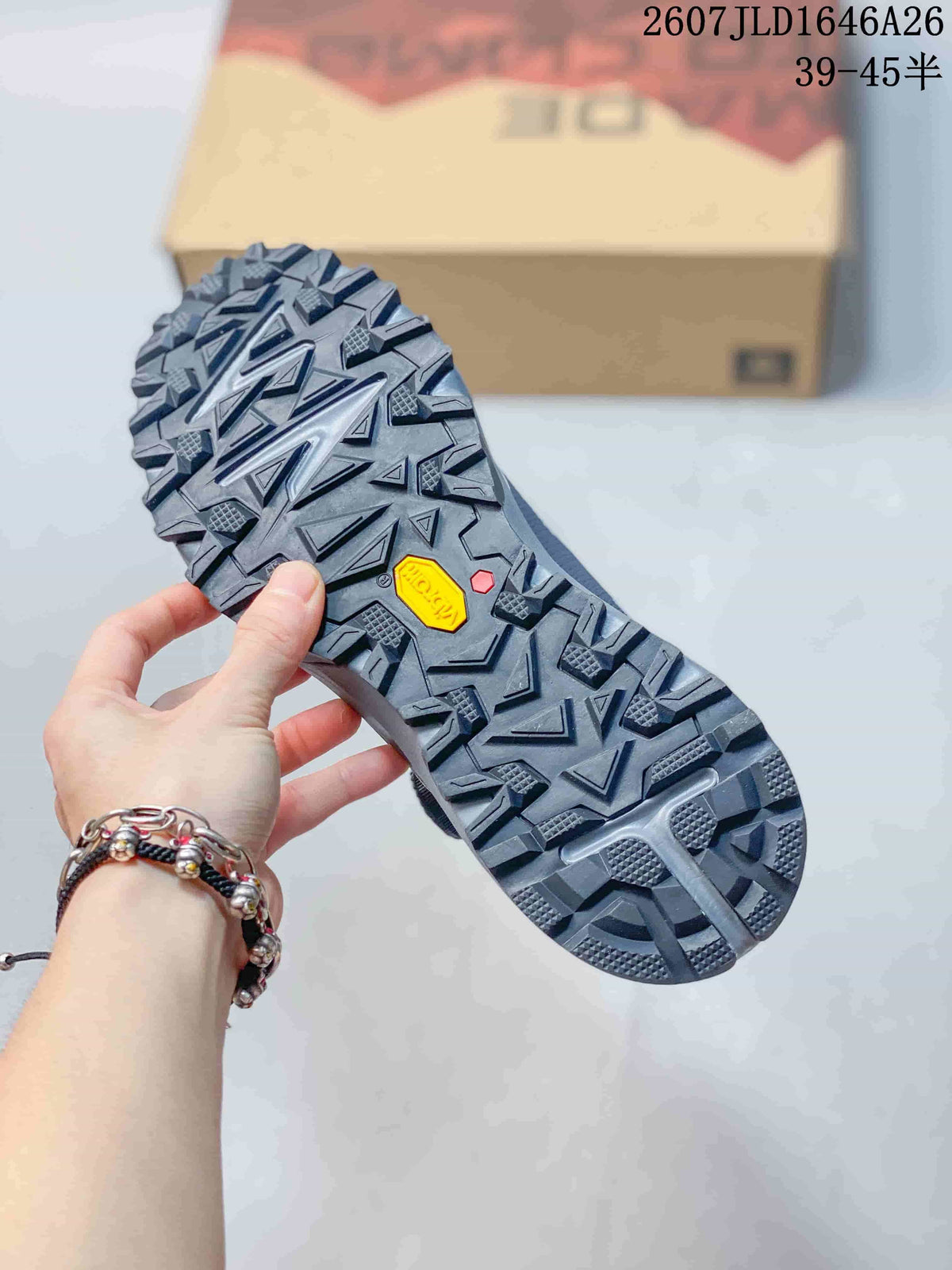 Close-up of the shoe outsole showing a deeply lugged tread pattern and a visible Vibram marking.