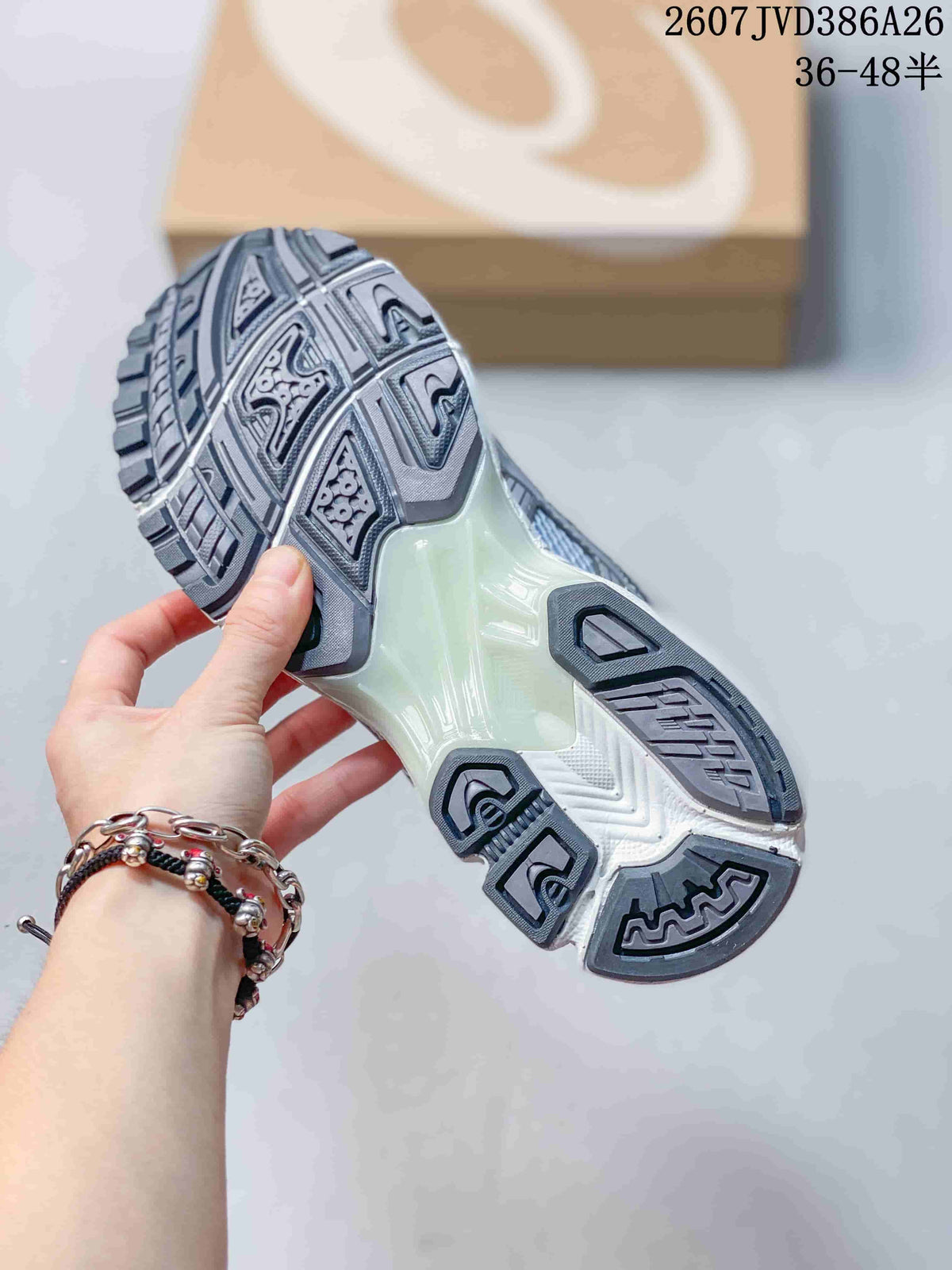 Underside view showing the segmented tread pattern and pale midsole of an ASICS sneaker.