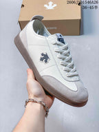 Close-up of a white and gray sneaker with a dark side emblem