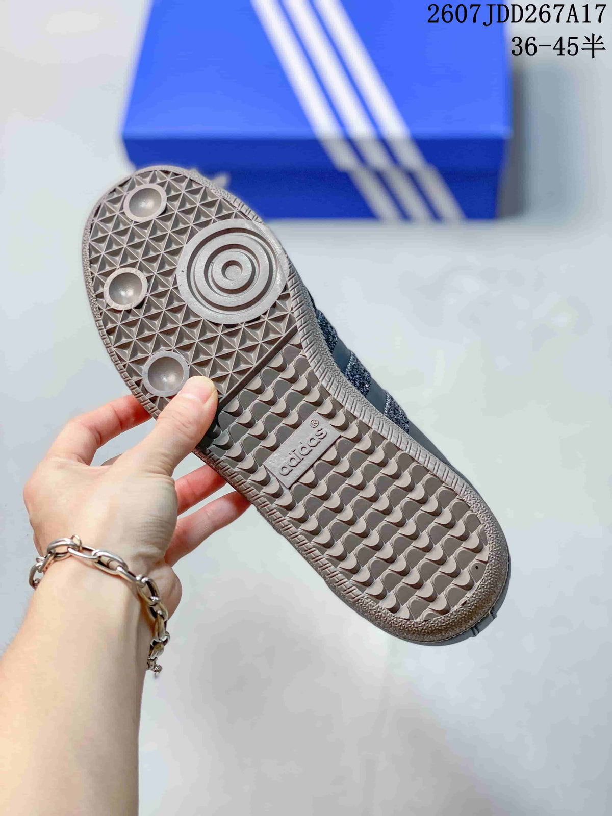 Bottom view of the sneaker showing the gum-colored outsole with circular and geometric tread details.