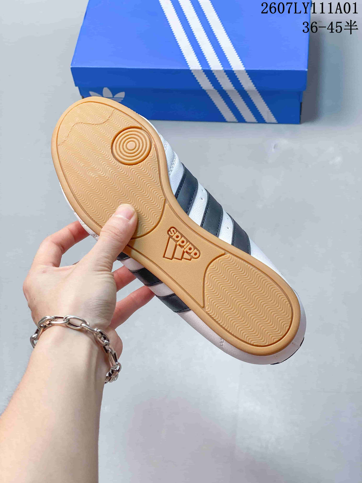 Underside of a Taekwondo shoe showing a gum-colored outsole with patterned tread.