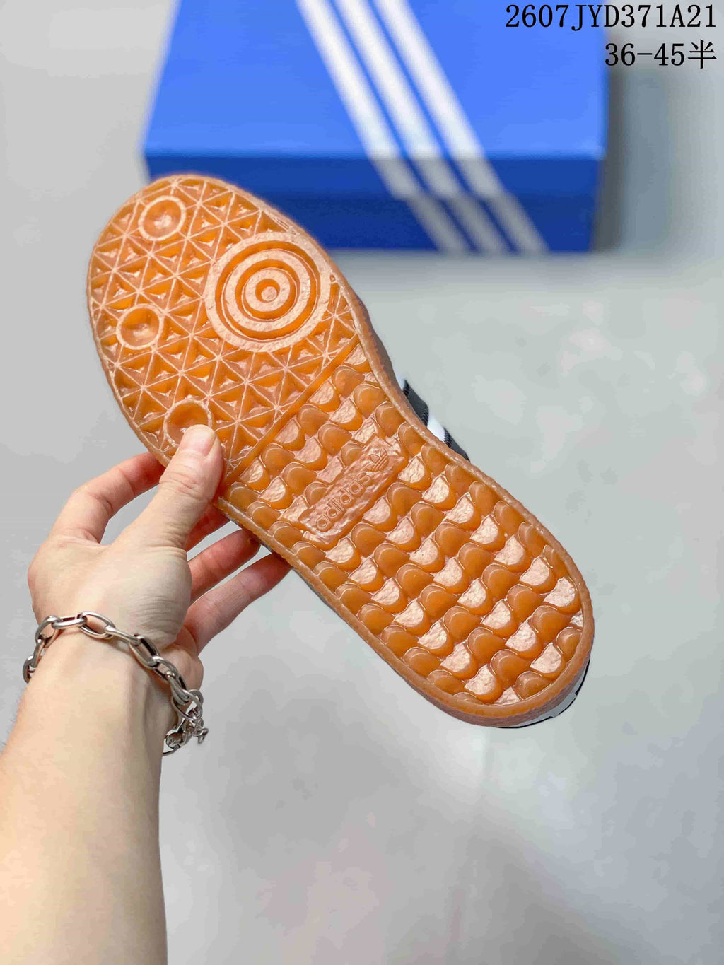 Close view of the gum-colored outsole showing its textured geometric tread pattern.