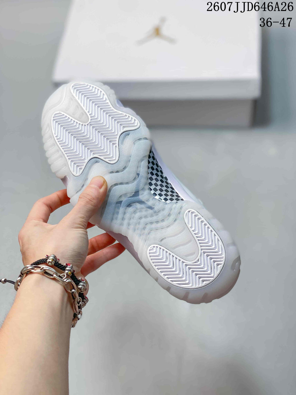 Close view of the translucent outsole with white herringbone traction sections and a patterned midfoot panel.