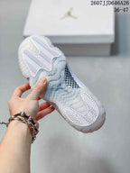 Close view of the translucent outsole with white herringbone traction sections and a patterned midfoot panel.