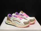Three-quarter front view of the pair with white uppers, beige overlays, pink laces, purple collars, and cream midsoles.
