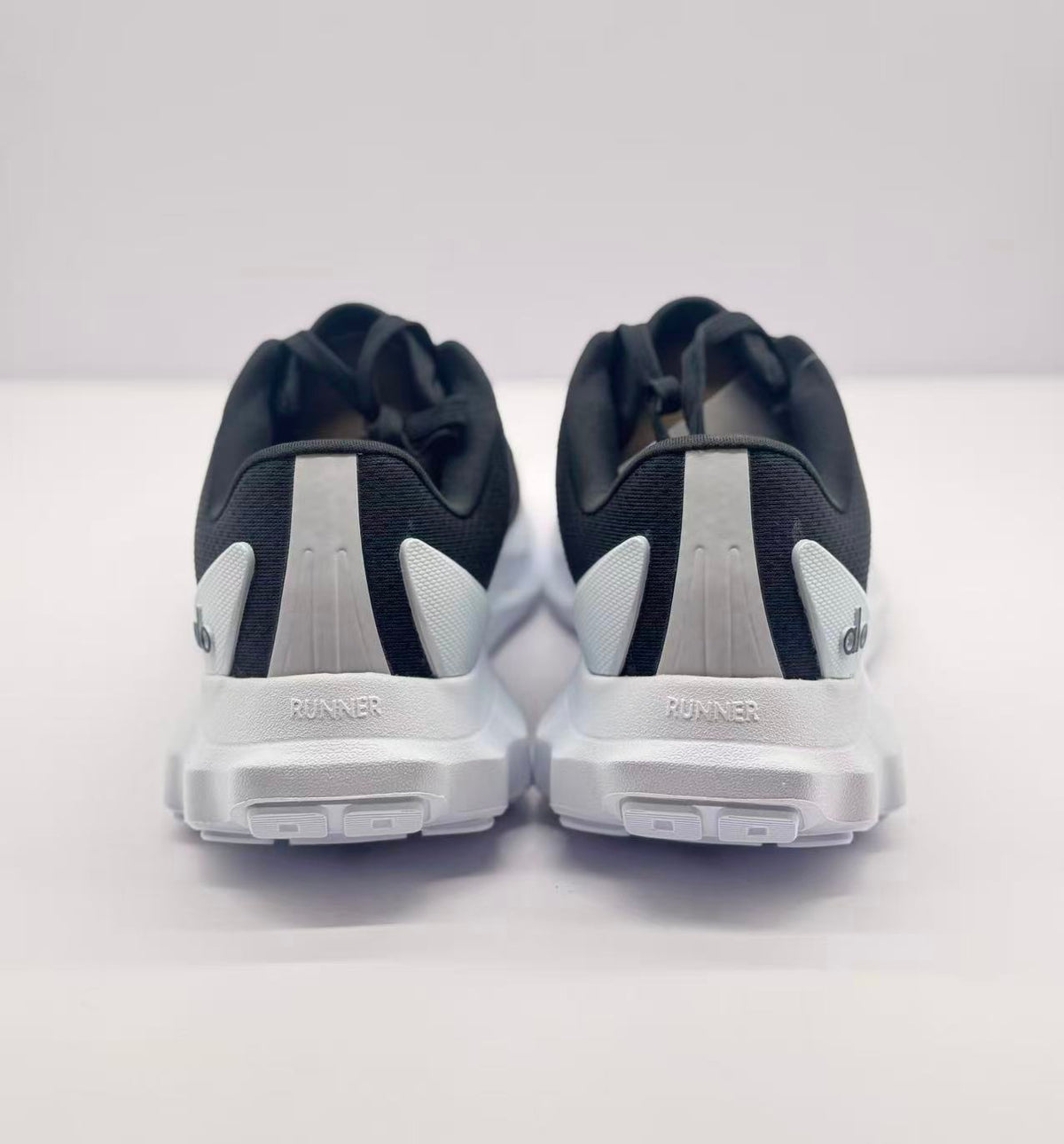 Rear view of the pair with Alo branding and RUNNER text on the heels.