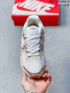 Top view showing the mesh toe box, white laces, padded tongue, and layered upper panels.
