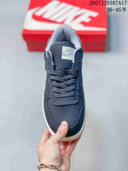 Top view of the navy sneaker showing the lace-up closure, padded tongue, and Nike tongue label.