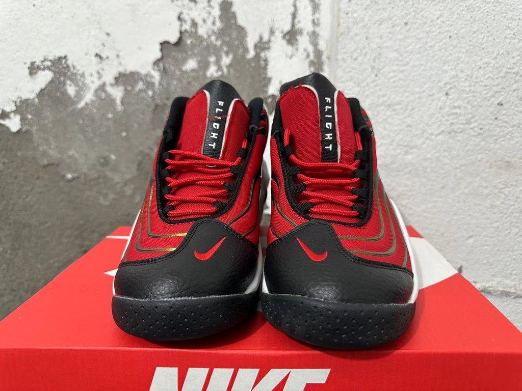 Front view of red and black Nike Flight sneakers with red laces and white midsoles