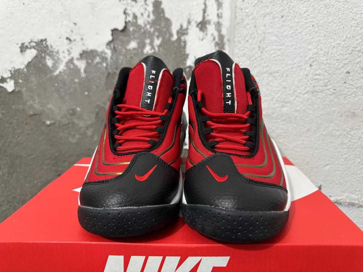 Front view of red and black Nike Flight sneakers with red laces and white midsoles