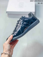 Side view showing the layered glossy panels, lace area and low-profile sole.