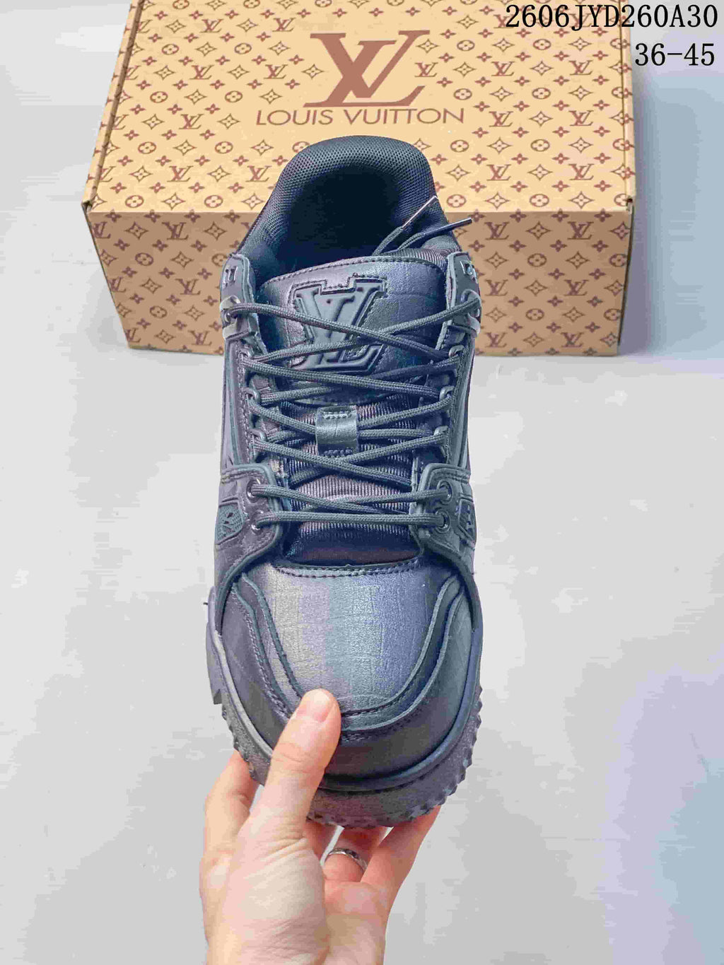 Top view of the lace-up sneaker with a logo-decorated tongue