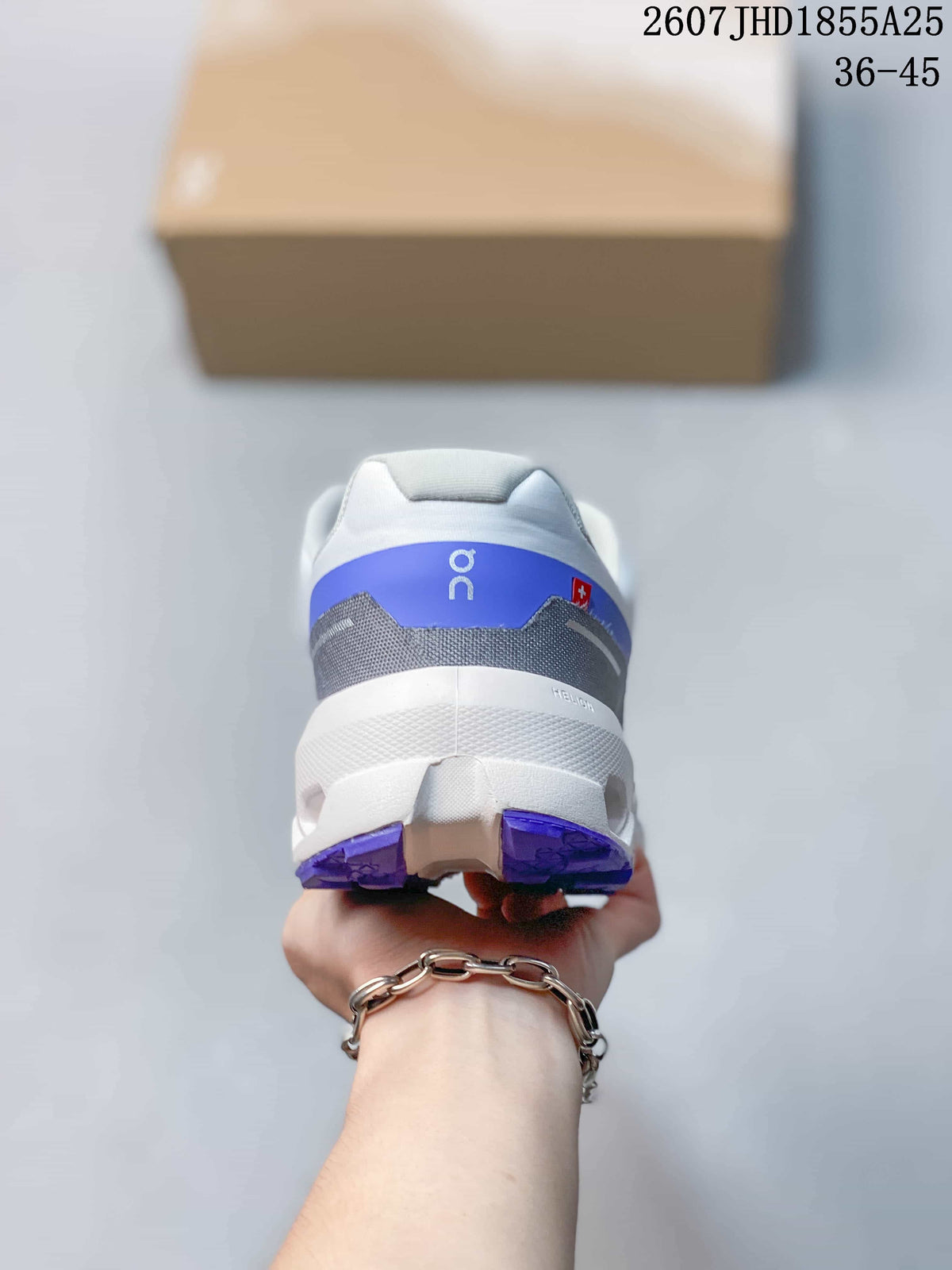 Rear view of the white and blue sneaker showing the padded heel collar, blue heel panel, and segmented outsole.