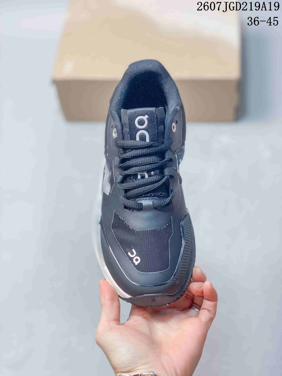 Top view of the black lace-up shoe showing the tongue, eyelets, laces, and contrasting branding; style code 2607TGD219A19 and size range 36-45 are visible.