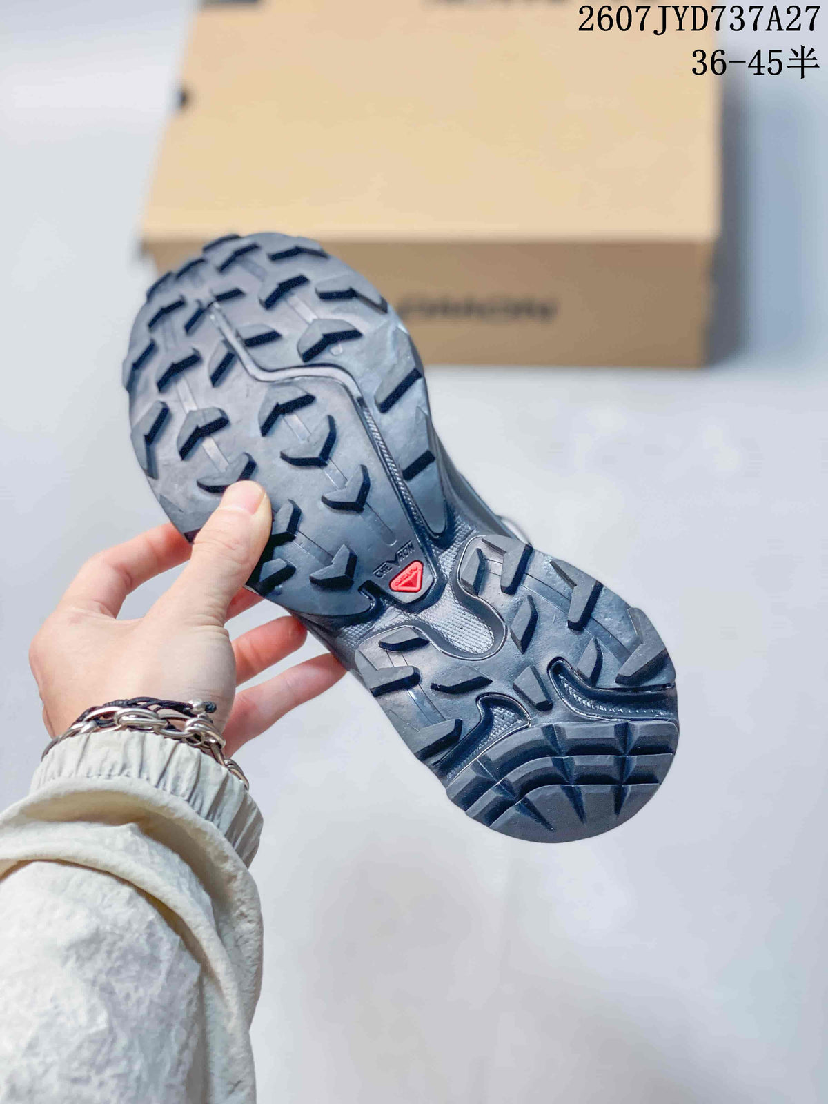 Close-up of the Salomon sneaker outsole showing a deep, multi-directional lug pattern.