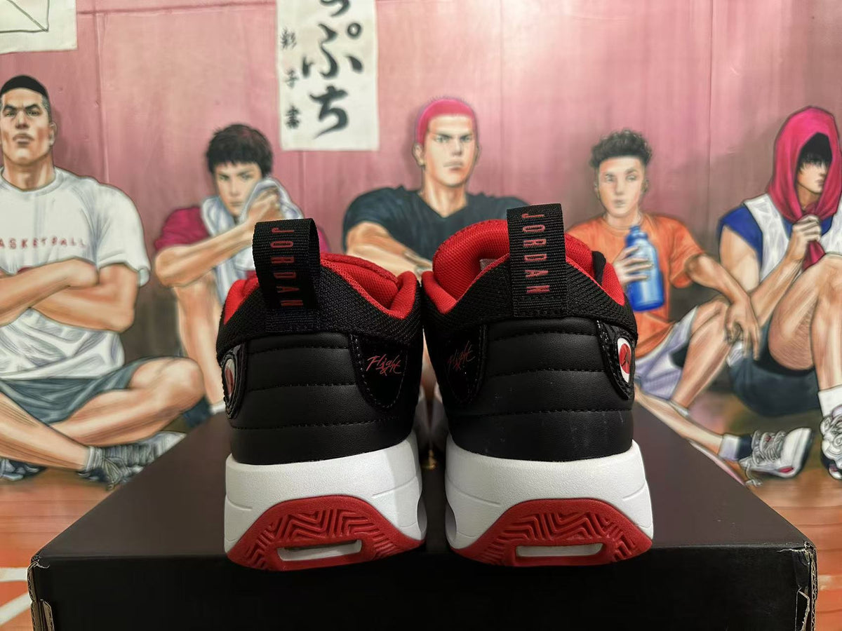 Rear view of black Jordan sneakers with red accents and white midsoles