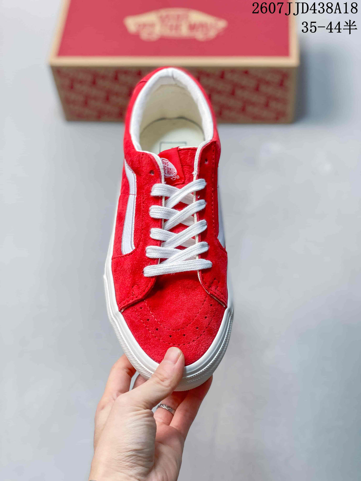 Top view of the red sneaker with white laces and white trim.