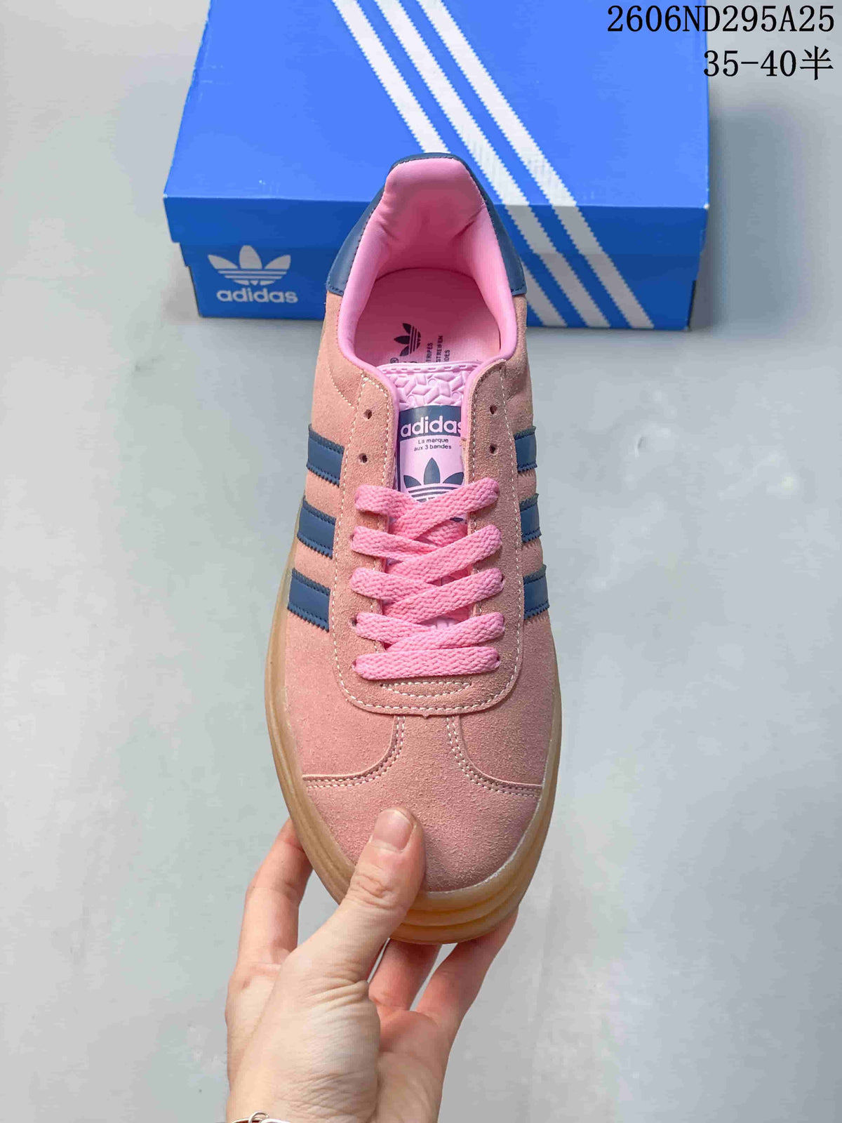 Top view showing the pink toe box, pink laces, navy stripes, and branded tongue.