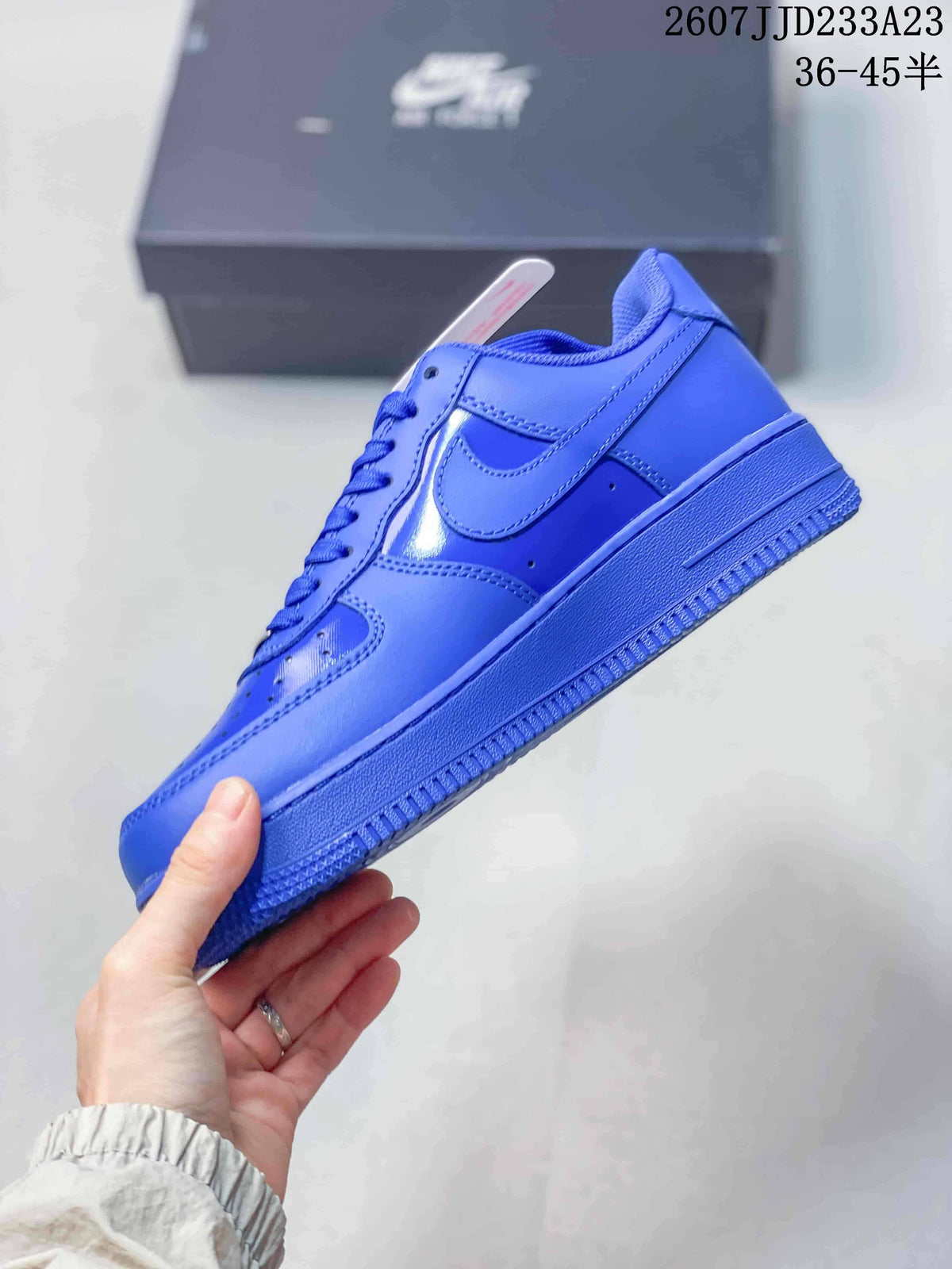 Side view of the blue low-top sneaker showing the Swoosh and layered upper panels.