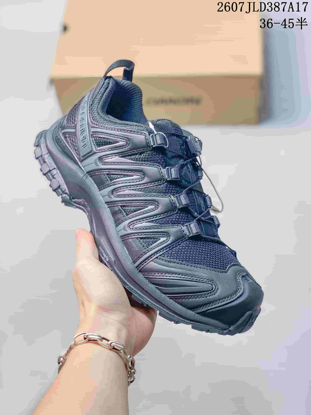 Angled side view of the black Salomon XA PRO 3D shoe showing the structured upper, padded collar, toe overlay, and textured outsole.