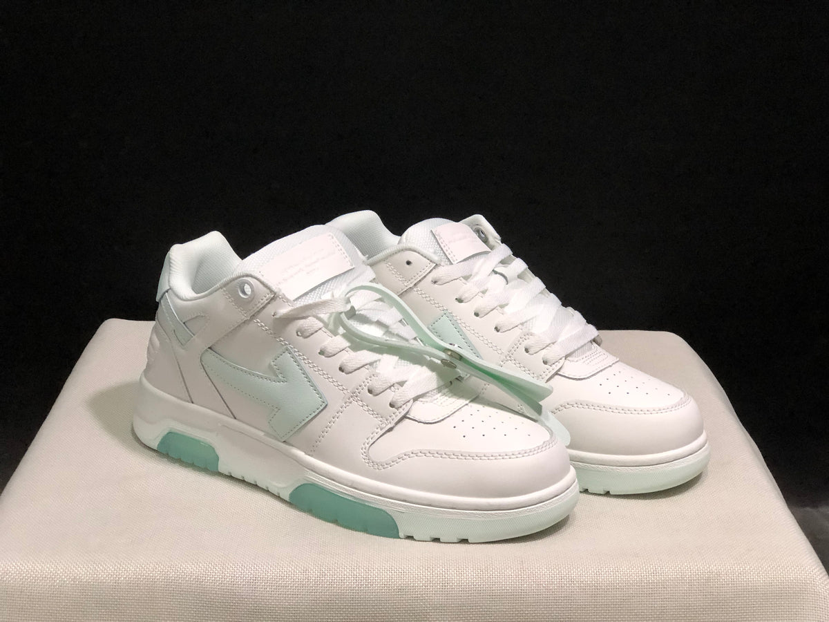 Three-quarter view of the pair highlighting the white upper, pale mint side accents and lace-up construction.