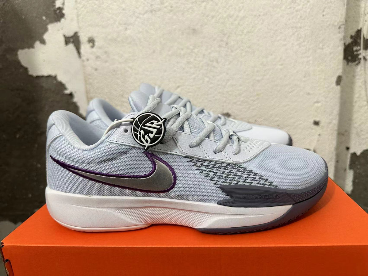 Side view showing the gray mesh panels and purple Swoosh on a Nike Ja 1 shoe
