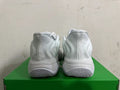 Rear view of white and grey Nike sneakers with sculpted heels and patterned outsoles