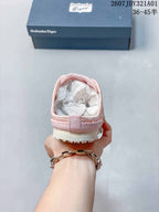 Rear view of the pink backless slip-on shoe showing its heel opening and outsole.