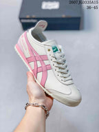 Close-up side view of a white and pink Onitsuka Tiger Mexico 66 Deluxe sneaker showing the side detailing, heel graphics, laces, and outsole.