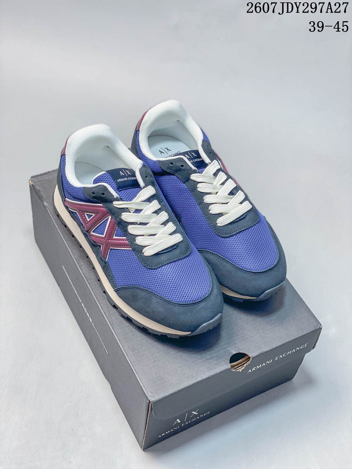 Pair of blue and burgundy Armani Exchange low-top sneakers displayed on a branded shoe box.
