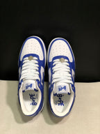 Top view showing the perforated white toe boxes, white laces, blue overlays, and branded insoles.