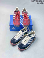 Burgundy and navy adidas SL 72 sneakers arranged together with a blue adidas shoebox.