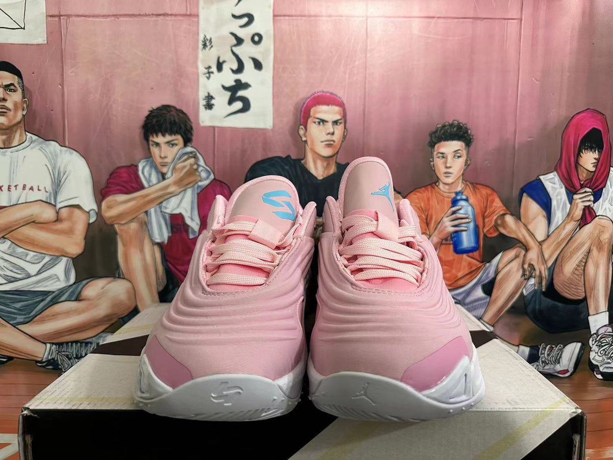 Front view of pink and white basketball shoes with turquoise tongue details