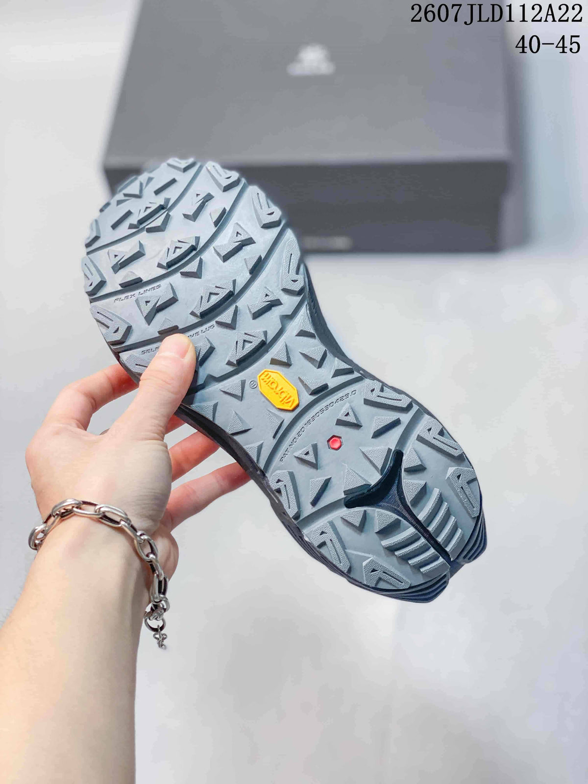 Close view of the lugged outsole with a visible Vibram logo and deep traction pattern.