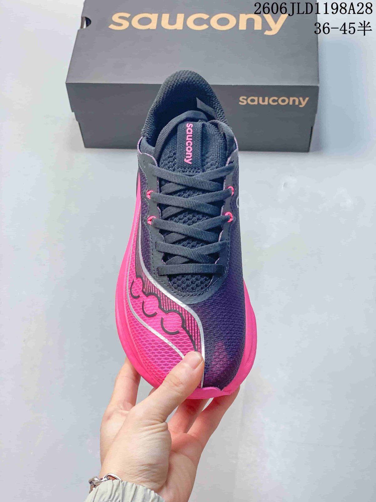 Top view of a navy and pink Saucony running shoe with dark laces
