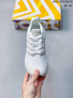 Top view of a white Adidas Ultraboost Light sneaker showing the lace-up closure, Adidas tongue branding and textured toe box.