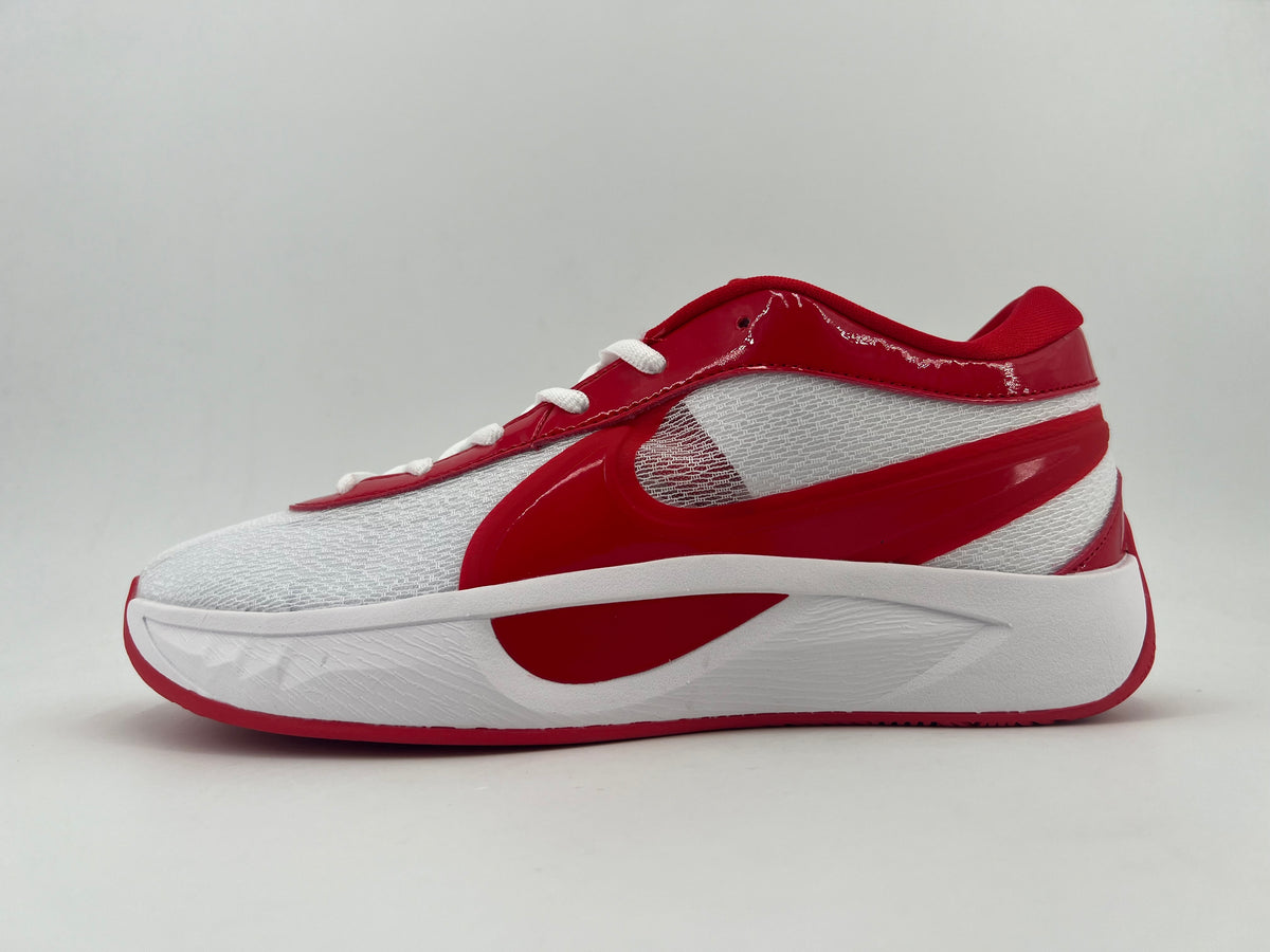 Side view of a white and red Nike low-top sneaker with white laces and a sculpted white midsole.