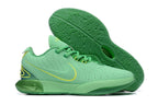 Mint green Nike basketball shoes with bright green patterned outsoles.