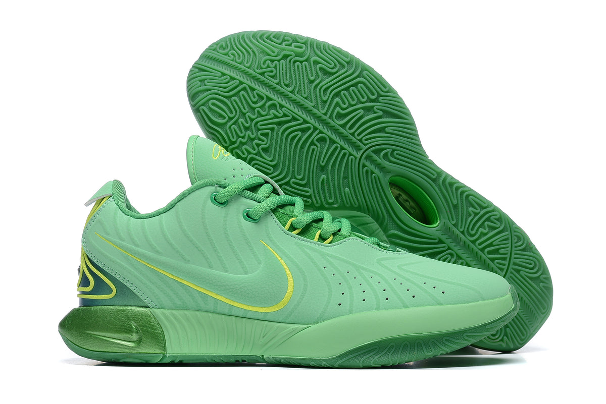 Mint green Nike basketball shoes with bright green patterned outsoles.