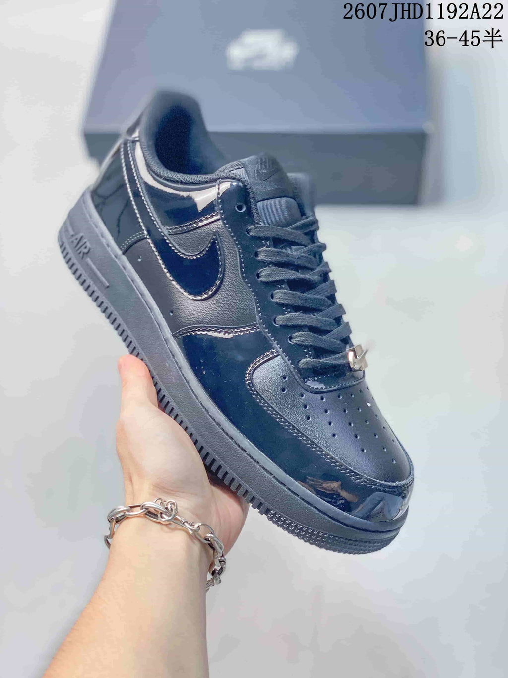 Angled side view of the black sneaker showing the low-top silhouette, swoosh panel, laces and rubber outsole.