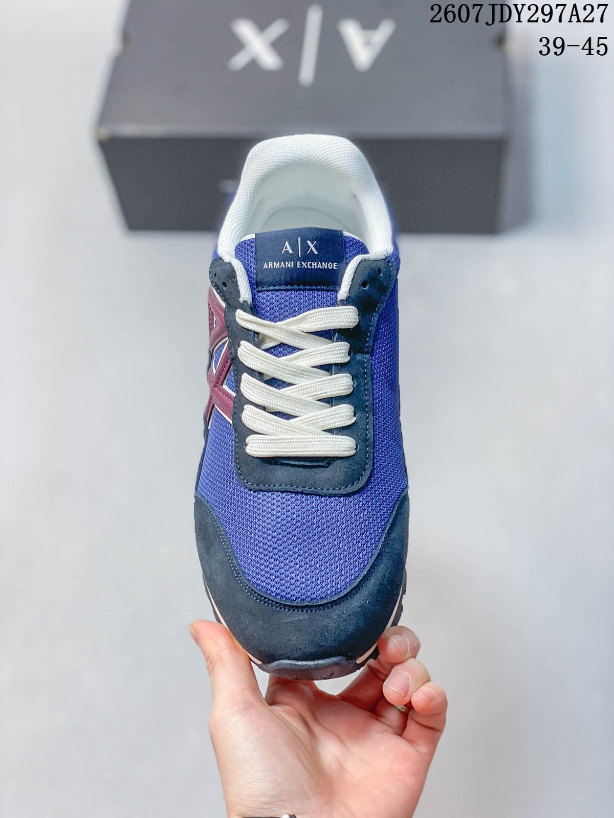 Front view showing the blue toe, white laces, dark overlays, and A|X tongue branding.