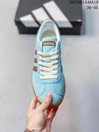 Top view of the light blue lace-up sneaker with cream laces and brown side detailing.