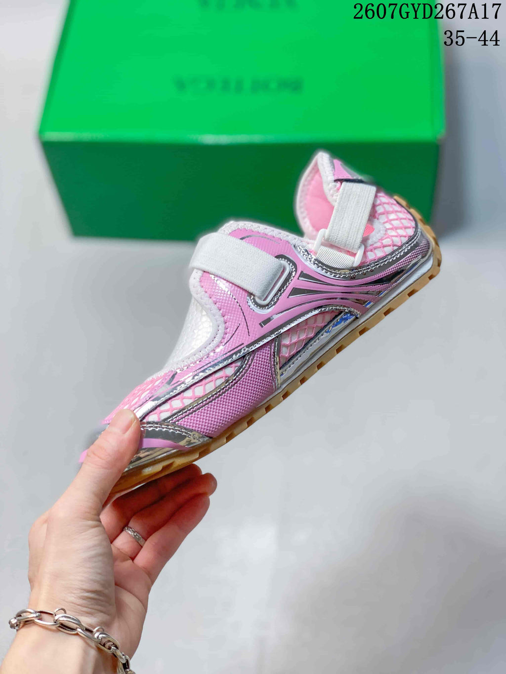 Side profile showing the wide hook-and-loop strap, pink panels, and metallic-looking overlays.