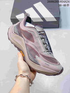 Side view of a mauve and gray trail running shoe with a chunky patterned sole