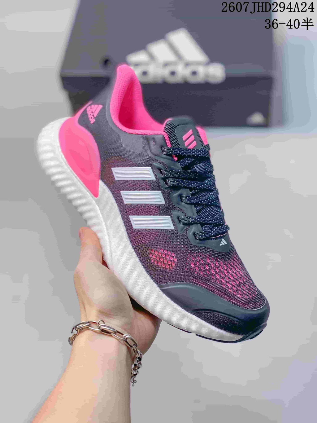 Angled side view of the black, pink and white adidas Switch FWD sneaker.
