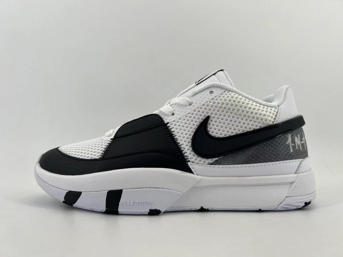 Side view of white, black, and gray Nike basketball shoes with mesh panels and a black Swoosh