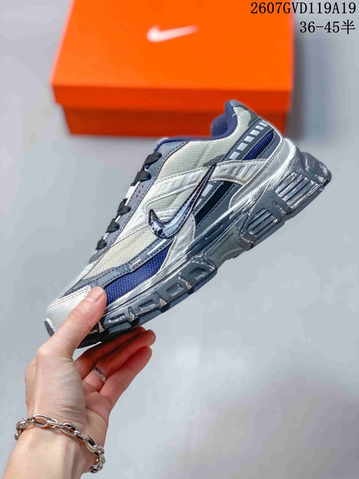 Side profile showing the layered panels, side Swoosh branding and treaded outsole.