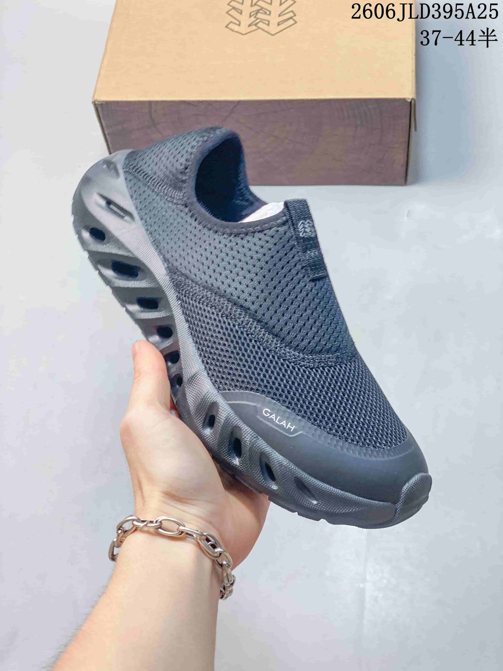 Close-up of a dark gray Galah slip-on shoe showing its upper and sculpted sole.